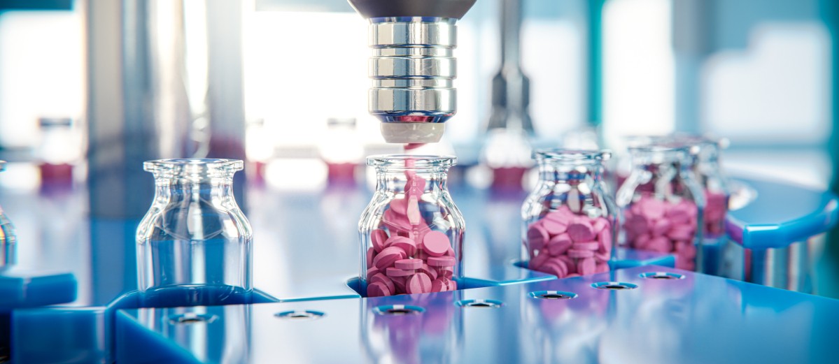 Jar filling with red tablets on a packaging line in a pharmaceutical factory 